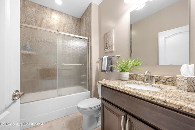 full bathroom with enclosed tub / shower combo, vanity, toilet, and tile patterned floors