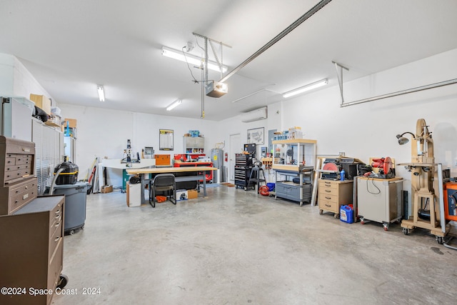 garage with a workshop area and a wall mounted air conditioner