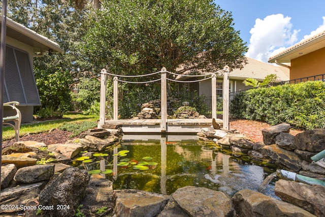 view of yard featuring a small pond