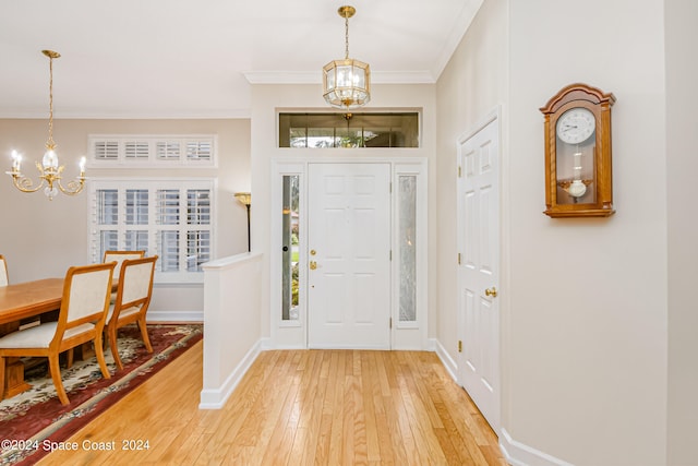 entrance foyer featuring a notable chandelier, hardwood / wood-style flooring, and a healthy amount of sunlight