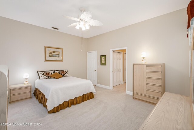 bedroom with ceiling fan and light carpet