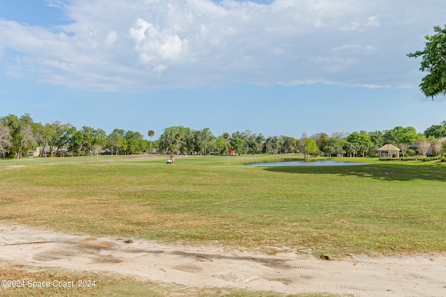 surrounding community featuring a yard and a water view