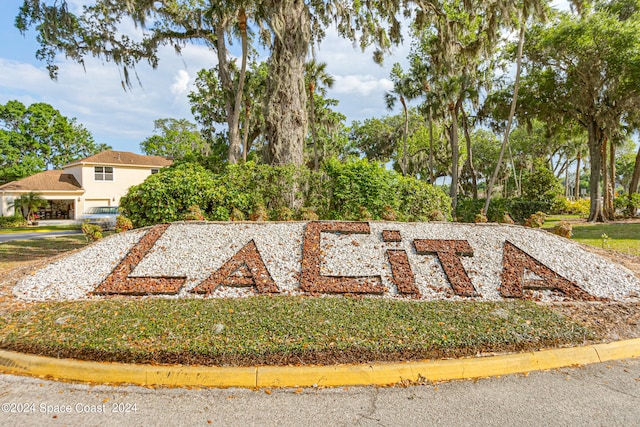 community / neighborhood sign featuring a garage