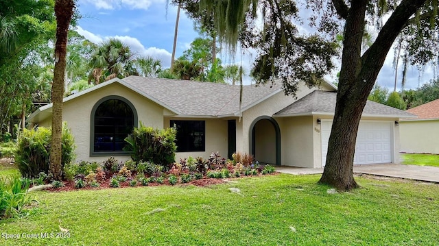 single story home with a garage and a front lawn