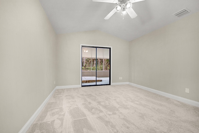 carpeted empty room featuring ceiling fan and vaulted ceiling