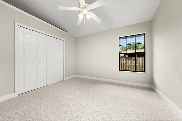 unfurnished bedroom featuring ceiling fan, a closet, and carpet