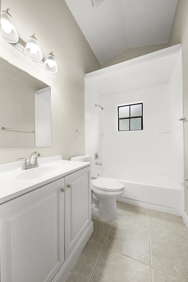 full bathroom featuring tile patterned flooring, vaulted ceiling, tiled shower / bath combo, vanity, and toilet