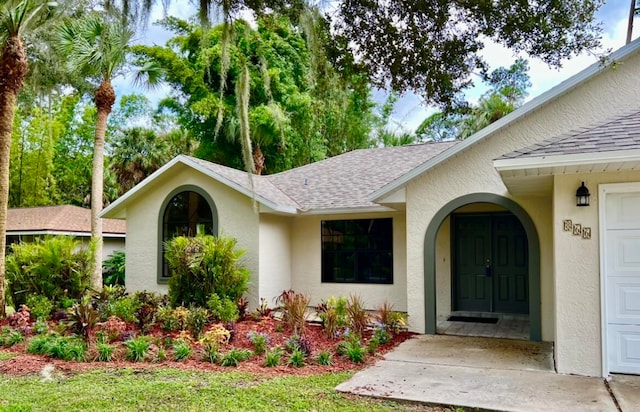 doorway to property with a garage