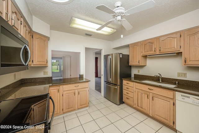 kitchen featuring black electric range oven, sink, stainless steel refrigerator, dishwasher, and a textured ceiling