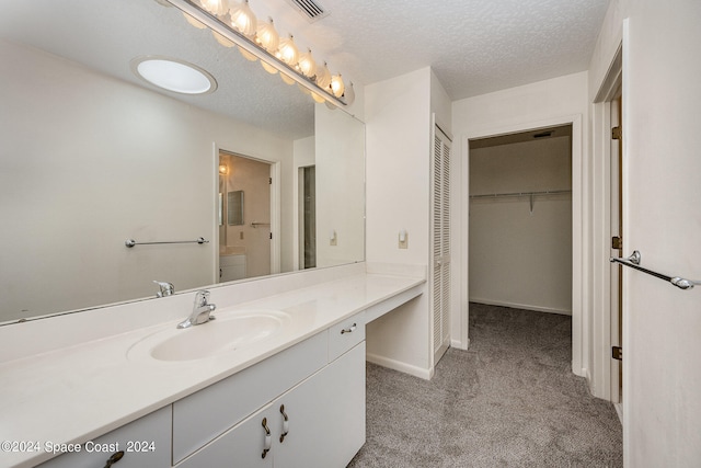 bathroom with vanity and a textured ceiling