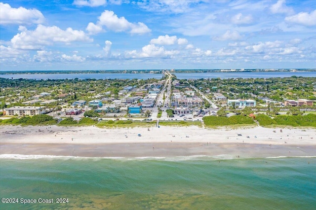 birds eye view of property featuring a water view and a beach view