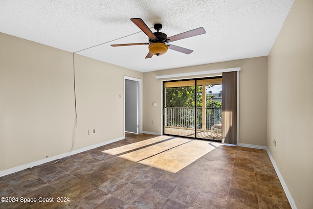 empty room with a textured ceiling and ceiling fan