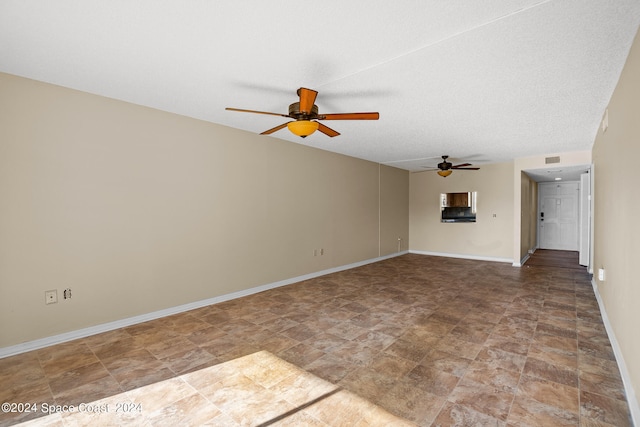 unfurnished living room with a textured ceiling and ceiling fan