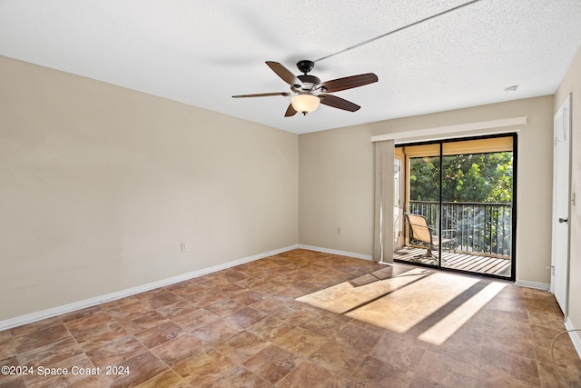 empty room featuring a textured ceiling and ceiling fan