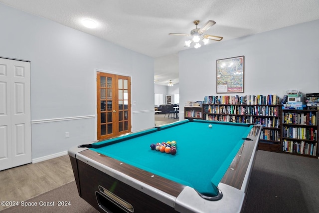 game room with french doors, a textured ceiling, light hardwood / wood-style flooring, and ceiling fan