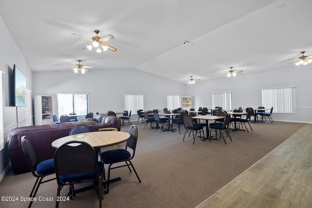 dining room featuring hardwood / wood-style flooring and lofted ceiling