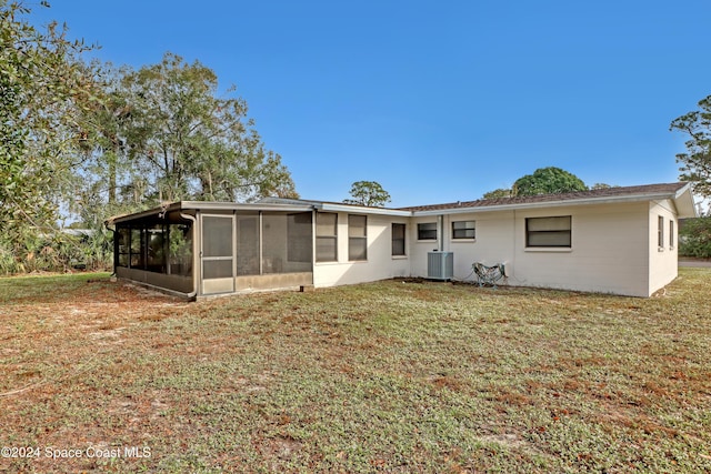 back of property featuring a lawn, central AC, and a sunroom