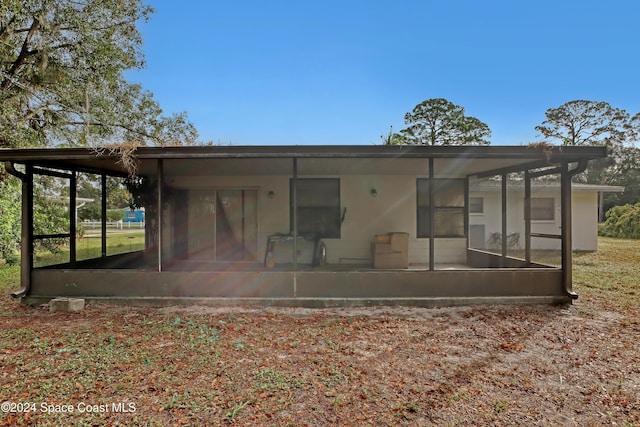 back of house featuring a sunroom