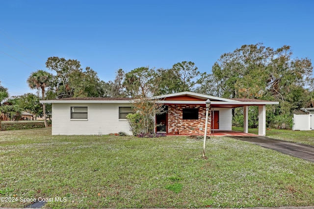 ranch-style house featuring a carport and a front yard