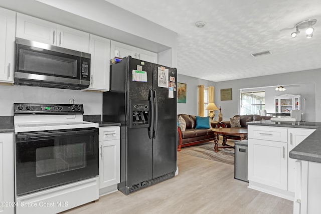 kitchen featuring white cabinets, black fridge with ice dispenser, and white electric range