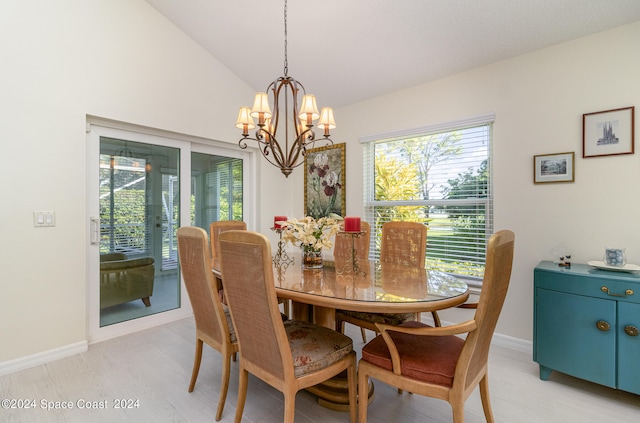 dining area with light hardwood / wood-style floors, vaulted ceiling, and a notable chandelier