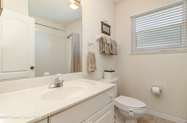 bathroom with tile patterned flooring, a shower with curtain, vanity, and toilet