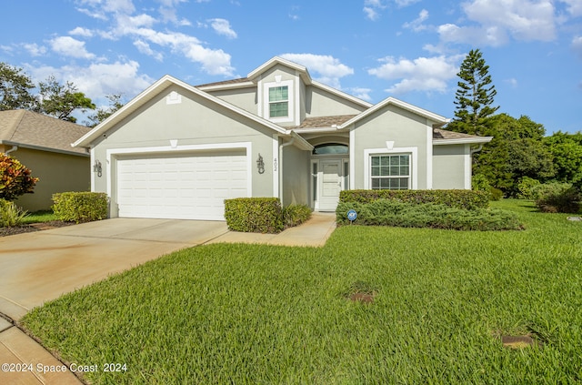 view of front of property featuring a garage and a front lawn