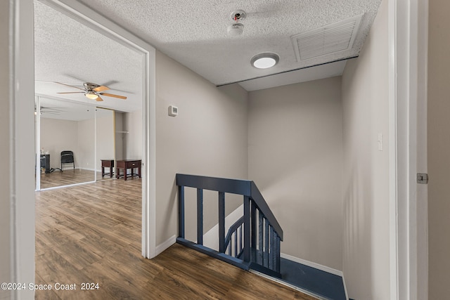 interior space featuring a textured ceiling and dark hardwood / wood-style flooring