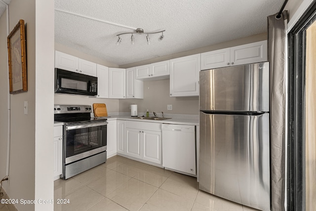 kitchen with white cabinets, a textured ceiling, and appliances with stainless steel finishes