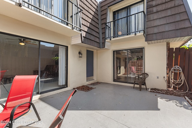 view of patio / terrace with a balcony and ceiling fan