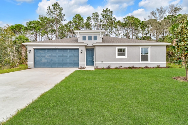 view of front of house featuring a front lawn and a garage