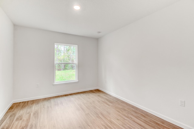 spare room with light hardwood / wood-style flooring