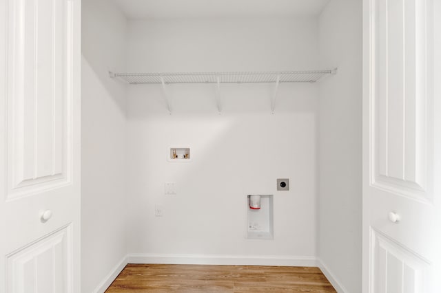 washroom with washer hookup, hookup for an electric dryer, and wood-type flooring