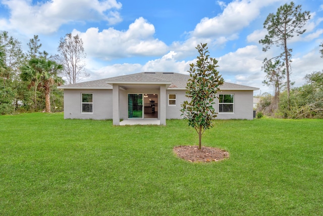 back of house with a patio and a yard