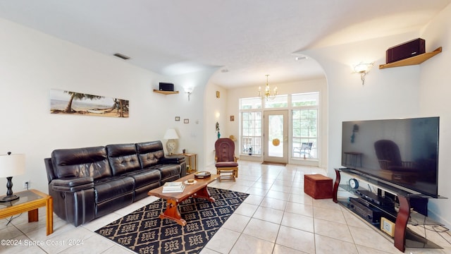 living room featuring light tile patterned floors, an inviting chandelier, and french doors