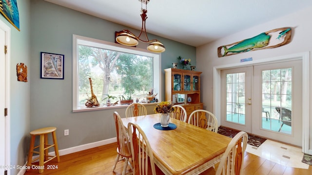 dining area featuring french doors and light hardwood / wood-style floors