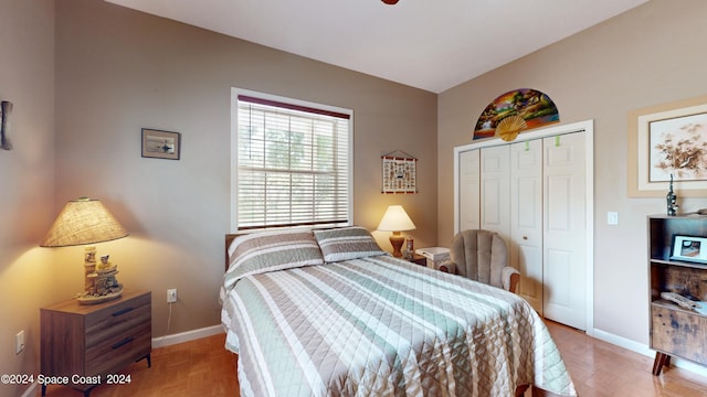 bedroom with light parquet flooring and a closet