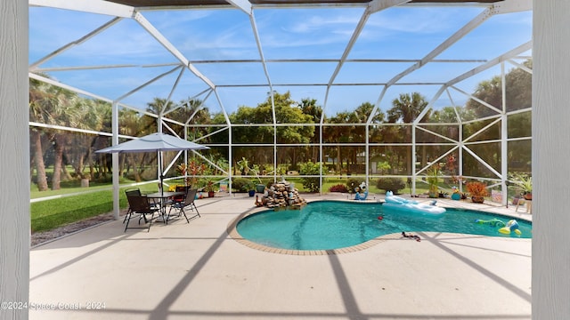 view of pool with a patio and a lanai