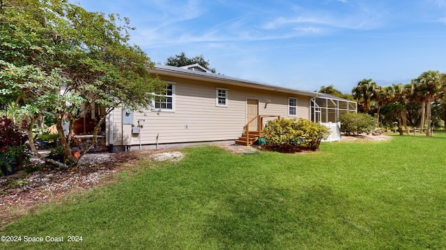 back of house with a lawn