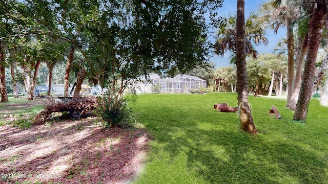 view of yard featuring glass enclosure