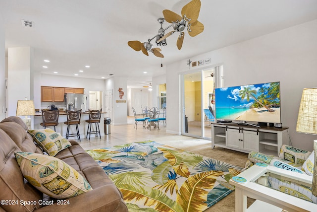 carpeted living room with ceiling fan