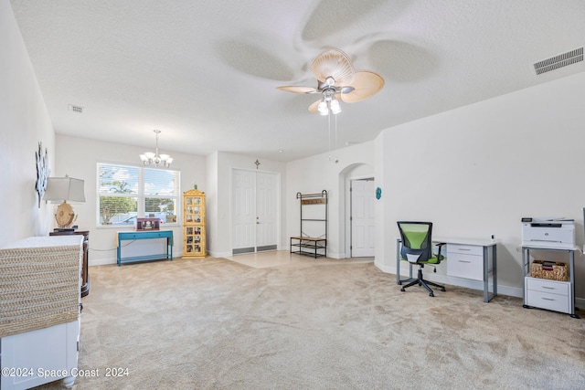 carpeted office featuring ceiling fan with notable chandelier and a textured ceiling