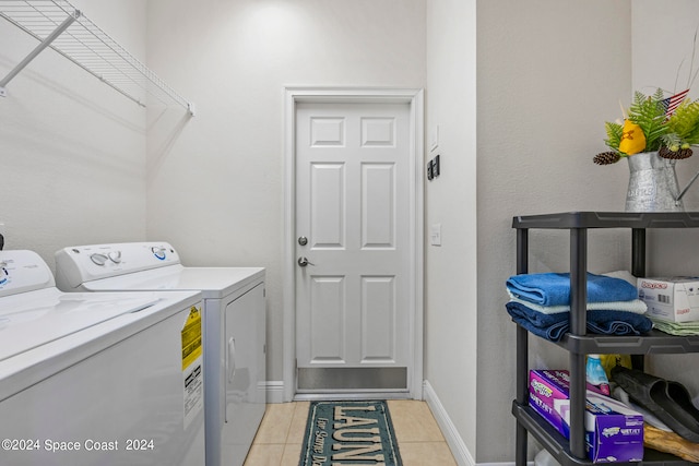 laundry room with light tile patterned flooring and independent washer and dryer