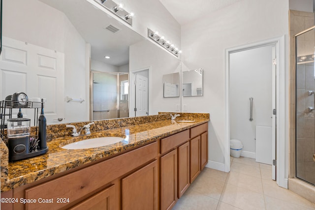 bathroom featuring tile patterned floors, walk in shower, and vanity