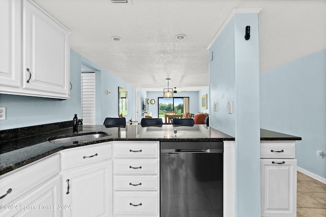 kitchen featuring light tile patterned flooring, sink, a textured ceiling, white cabinetry, and dark stone countertops