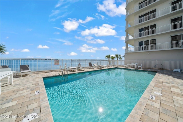 view of pool with a water view