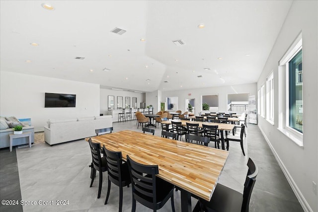 dining space featuring vaulted ceiling