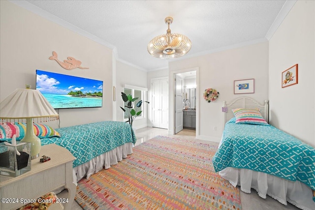 bedroom featuring a notable chandelier, crown molding, ensuite bathroom, and a textured ceiling