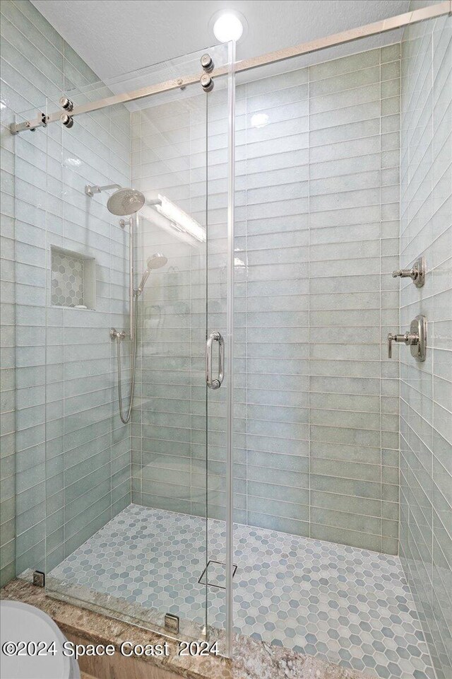 bathroom with a shower with shower door