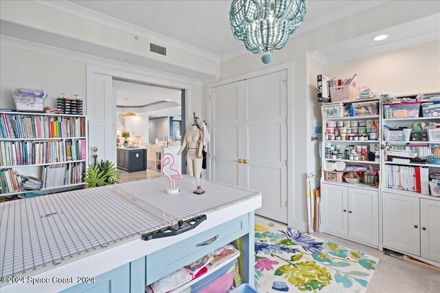 interior space featuring an inviting chandelier, a closet, and ornamental molding